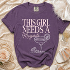 Purple t-shirt with "This Girl Needs a Margarita" text and cocktail graphic.