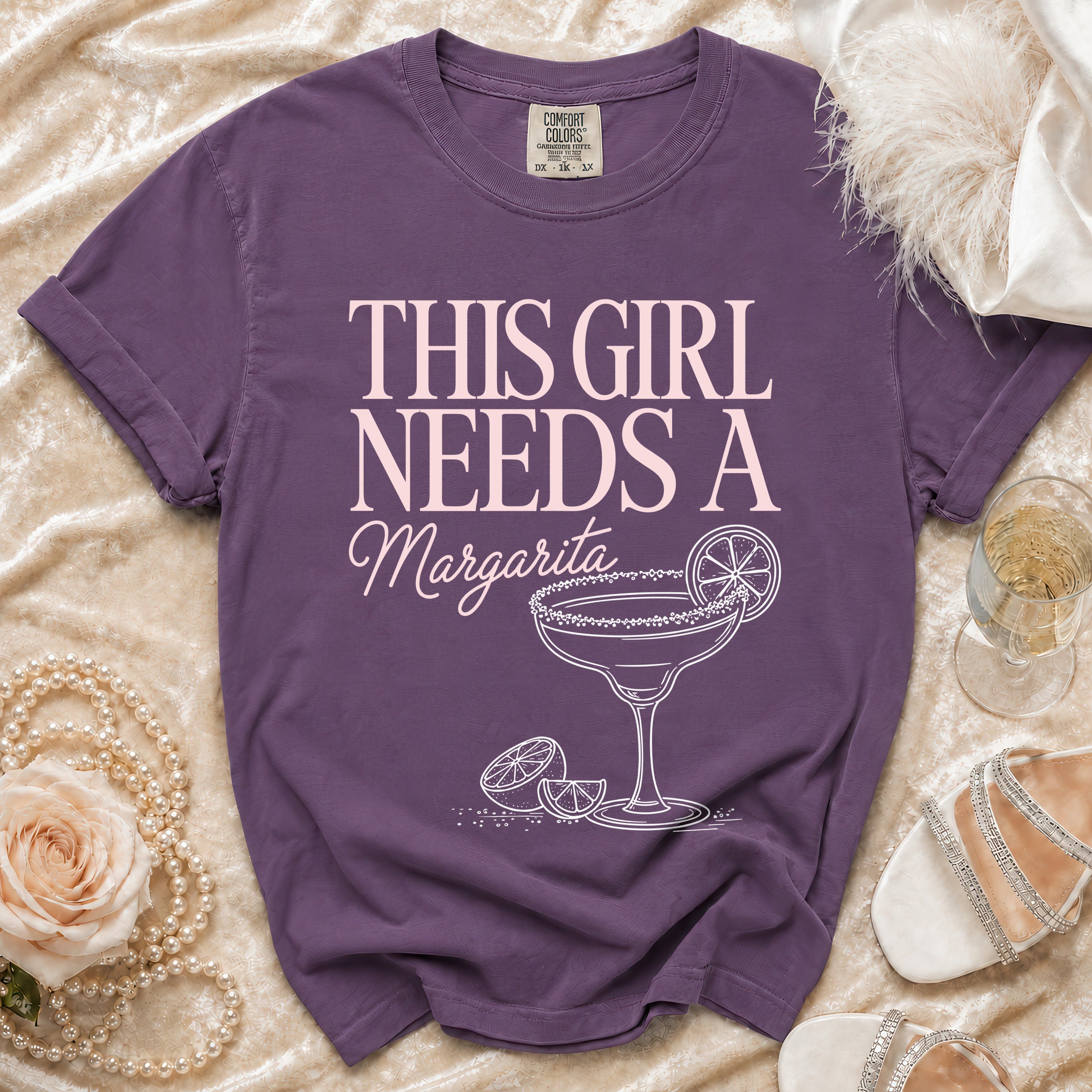 Purple t-shirt with "This Girl Needs a Margarita" text and cocktail graphic.