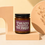 Amber jar candle with "Fabulous Mother of the Bride" text on purple label.