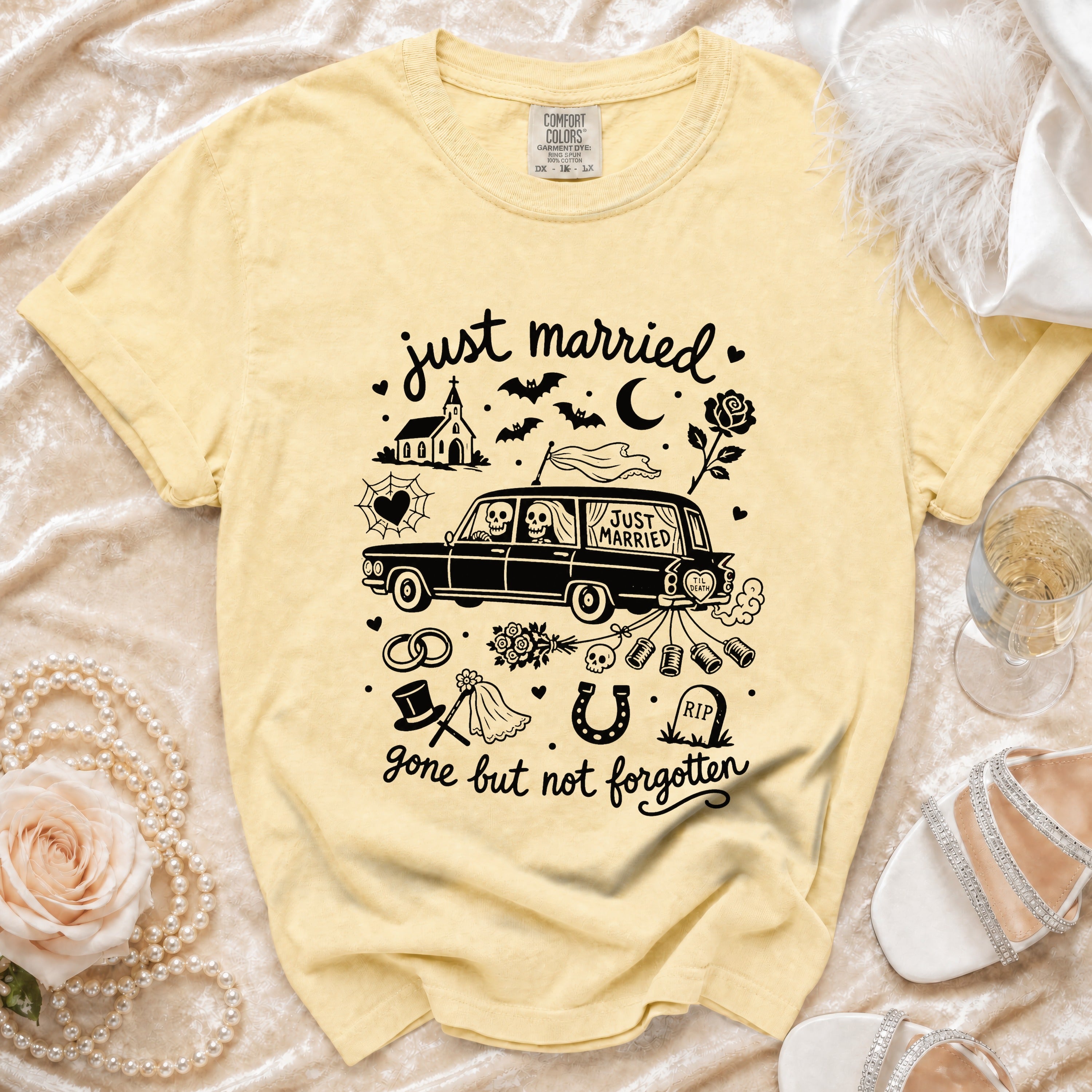 Yellow t-shirt with "just married" graphic of skeleton couple in car, church, bats, and "gone but not forgotten".
