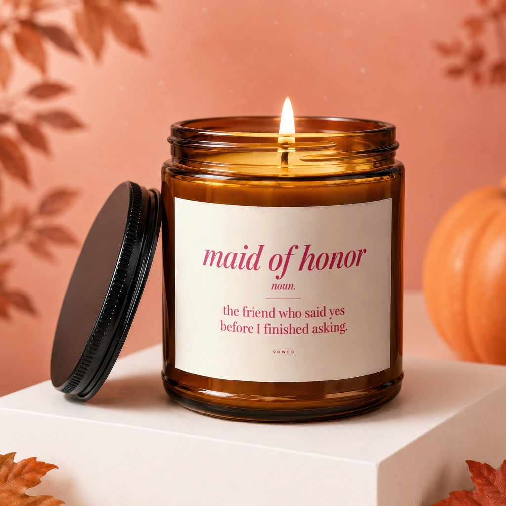 Brown glass candle with "maid of honor" and definition on label.