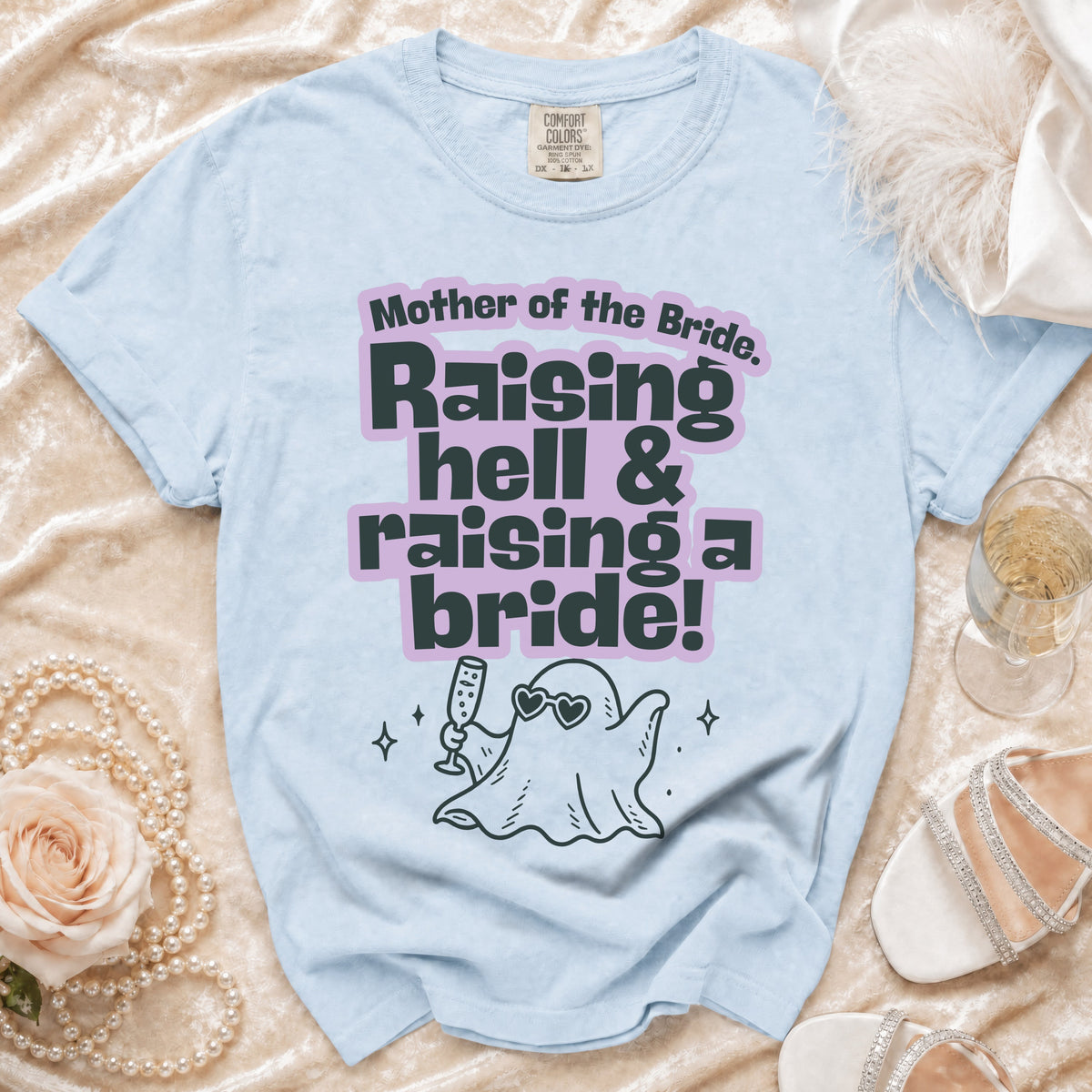 Light blue t-shirt with "Mother of the Bride. Raising hell & raising a bride!" text and ghost graphic.