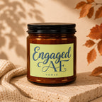 Amber jar candle with "Engaged AF" text and "vowed" below on a textured surface.