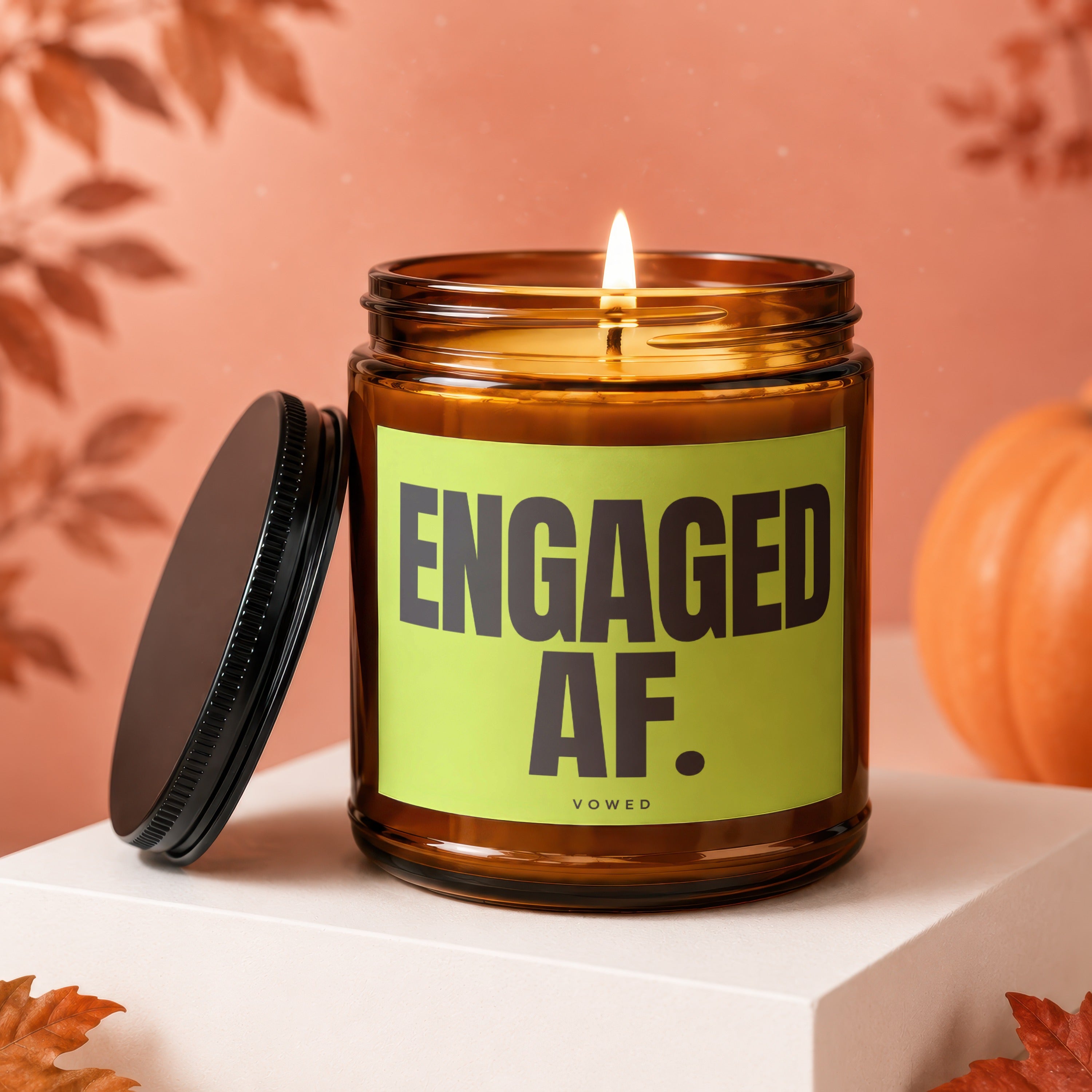 Amber jar candle with "Engaged AF Vowed" text on a bright green label.