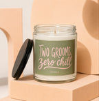 Candle with green label reading "TWO GROOMS, ZERO CHILL" and "VOWED."