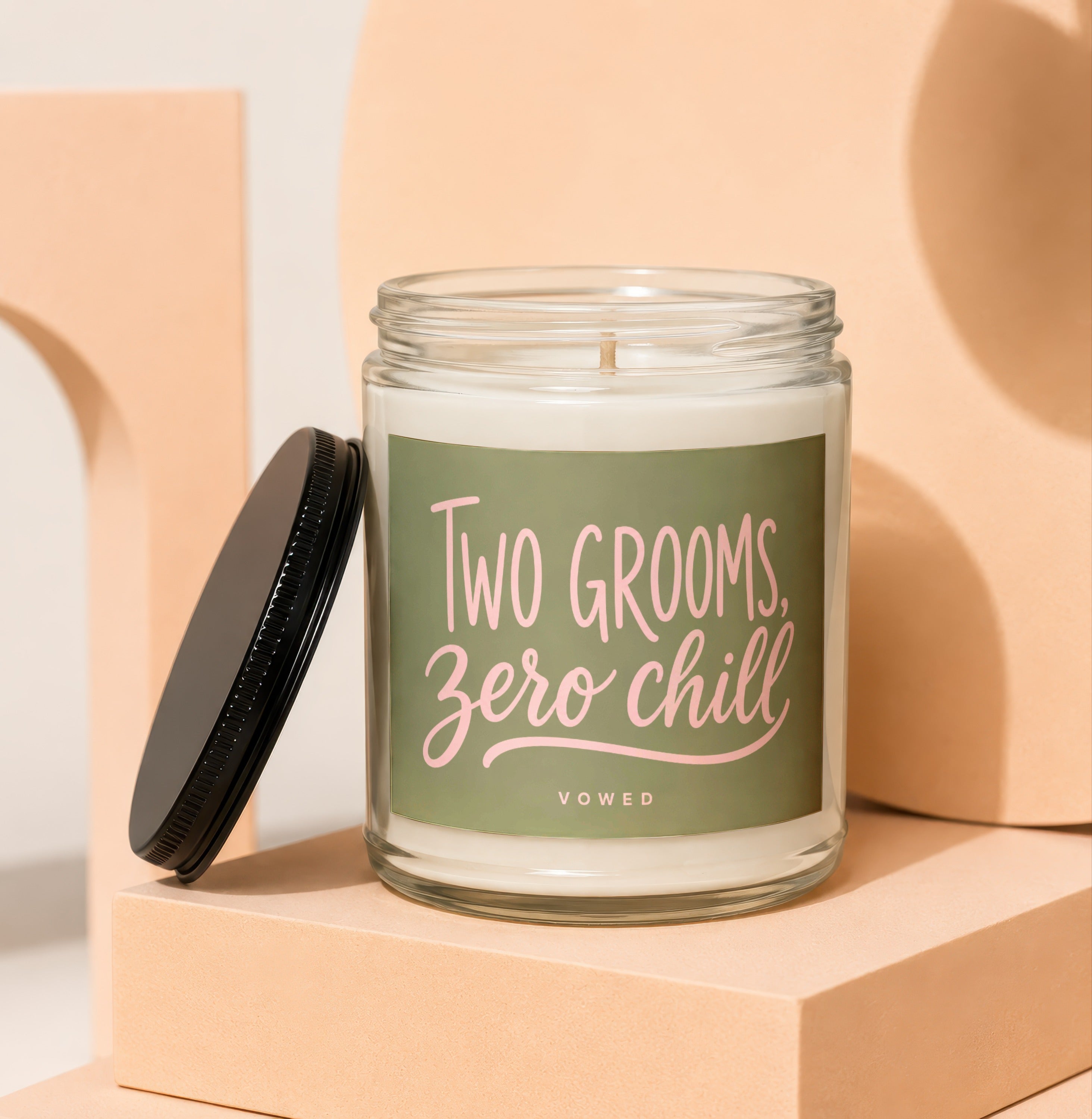 Candle with green label reading "TWO GROOMS, ZERO CHILL" and "VOWED."