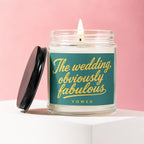 Candle with teal label reading "The wedding, obviously fabulous" in yellow script.