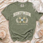 Green t-shirt with "Honeymoon Social Club Just Married" text and key design.