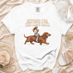White t-shirt with illustration of a bride riding a dachshund, text reads "Hitched for the Long Haul".