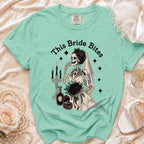 T-shirt with "This Bride Bites" text and a skeleton bride with black roses and wedding items.