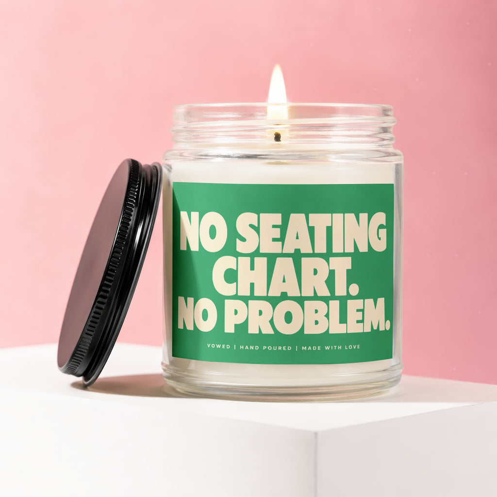 Glass candle with green label reading "NO SEATING CHART. NO PROBLEM."