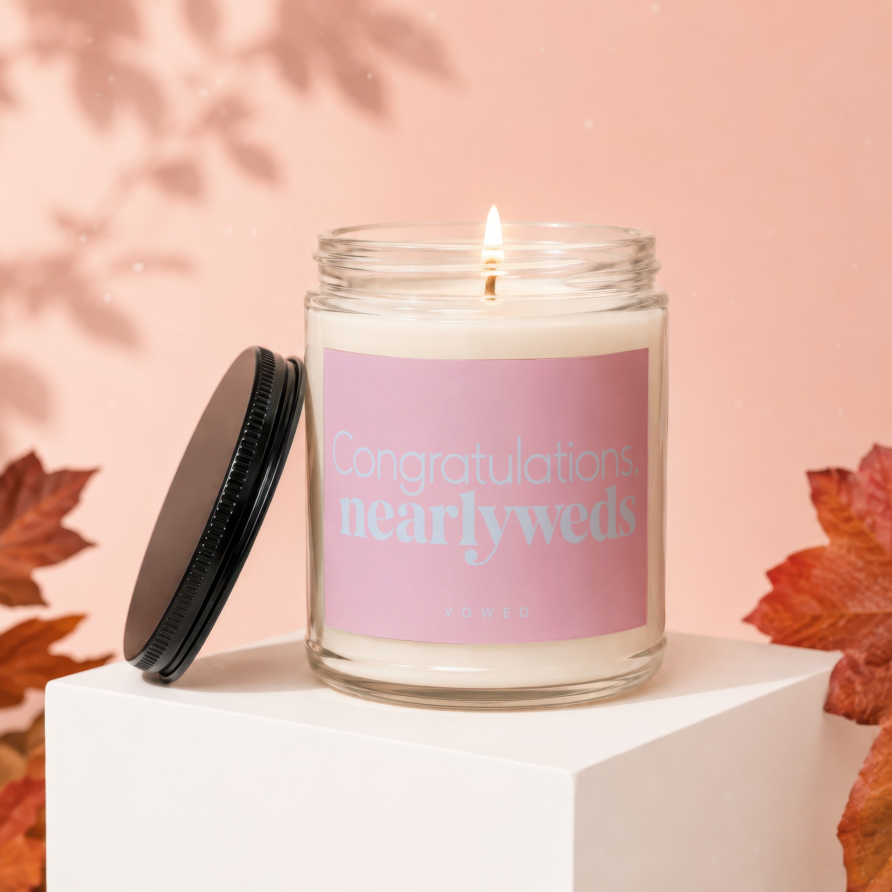 Candle with pink label that says "Congratulations, nearlyweds" and "vowed".