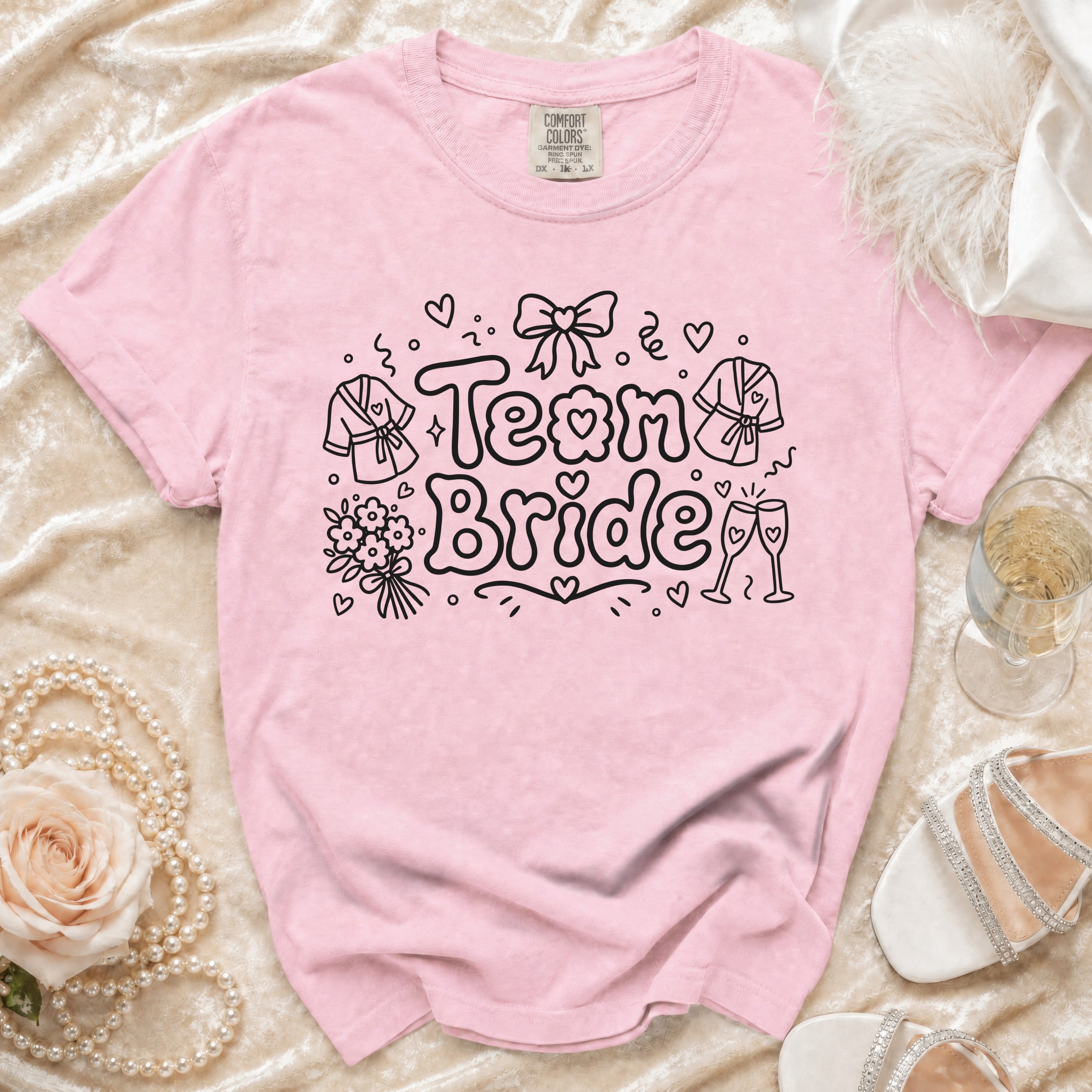 Pink t-shirt with "Team Bride" graphic and wedding-themed icons.