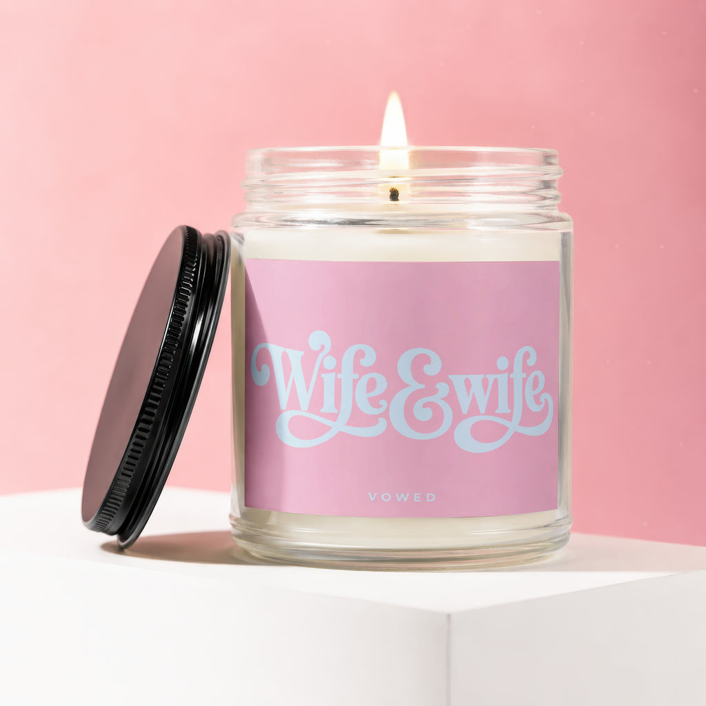Candle with "Wife & Wife" and "VOWED" text on a pink background.