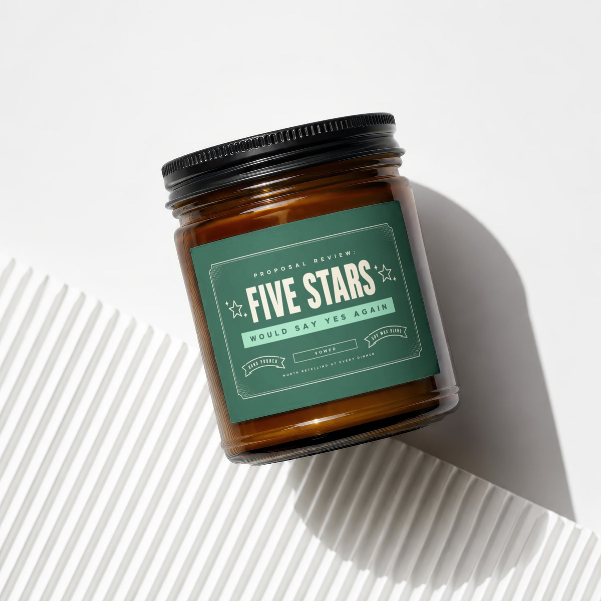 Amber candle with green label reading "Five Stars Would Say Yes Again."