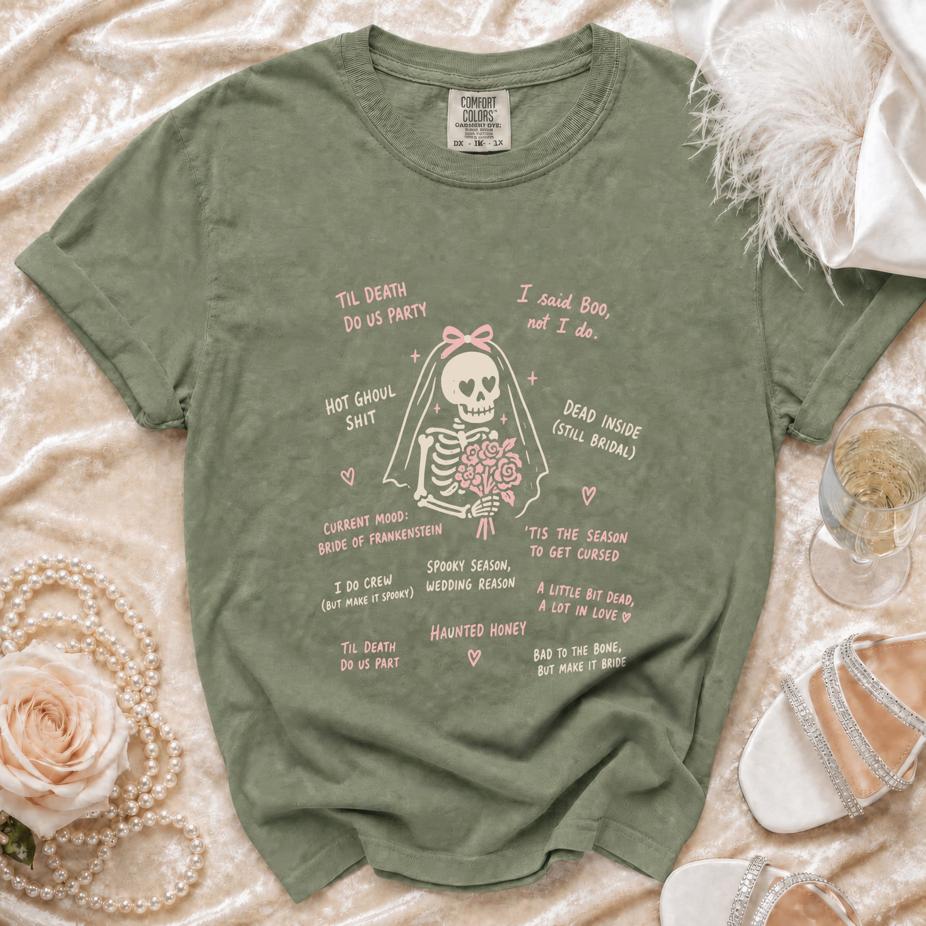 Olive green t-shirt with skeleton bride graphic and pink text quotes.