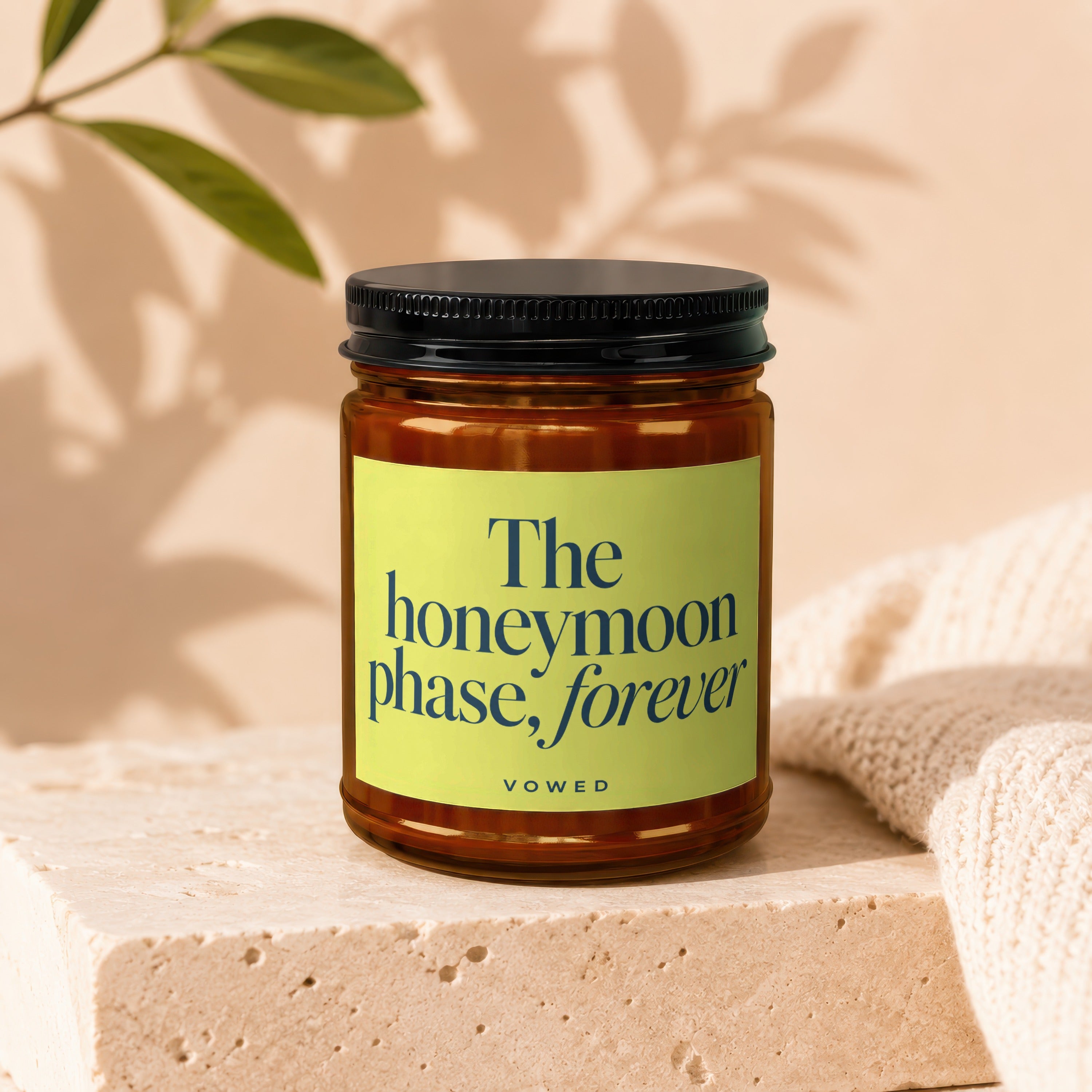 Glass jar with black lid and yellow label reading "The honeymoon phase, forever"