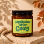 Amber candle with a yellow label reading "Happily Ever After Cozy" and "vowed".