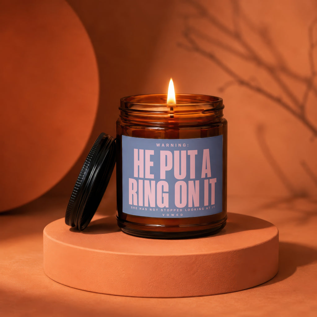 Amber glass candle with "He Put a Ring on It" and "Vowed" text.