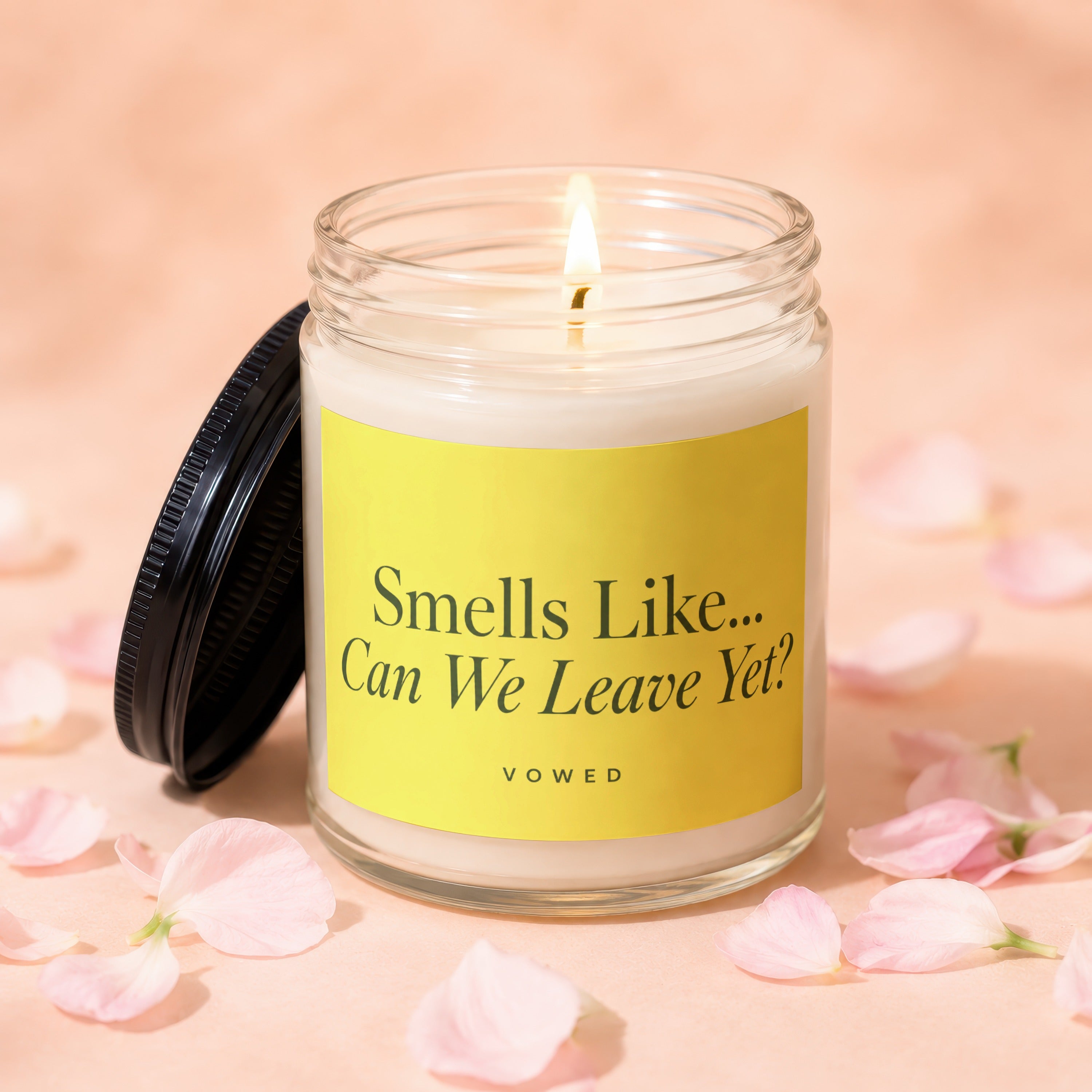 Candle with yellow label, saying "Smells Like... Can We Leave Yet? VOWED."