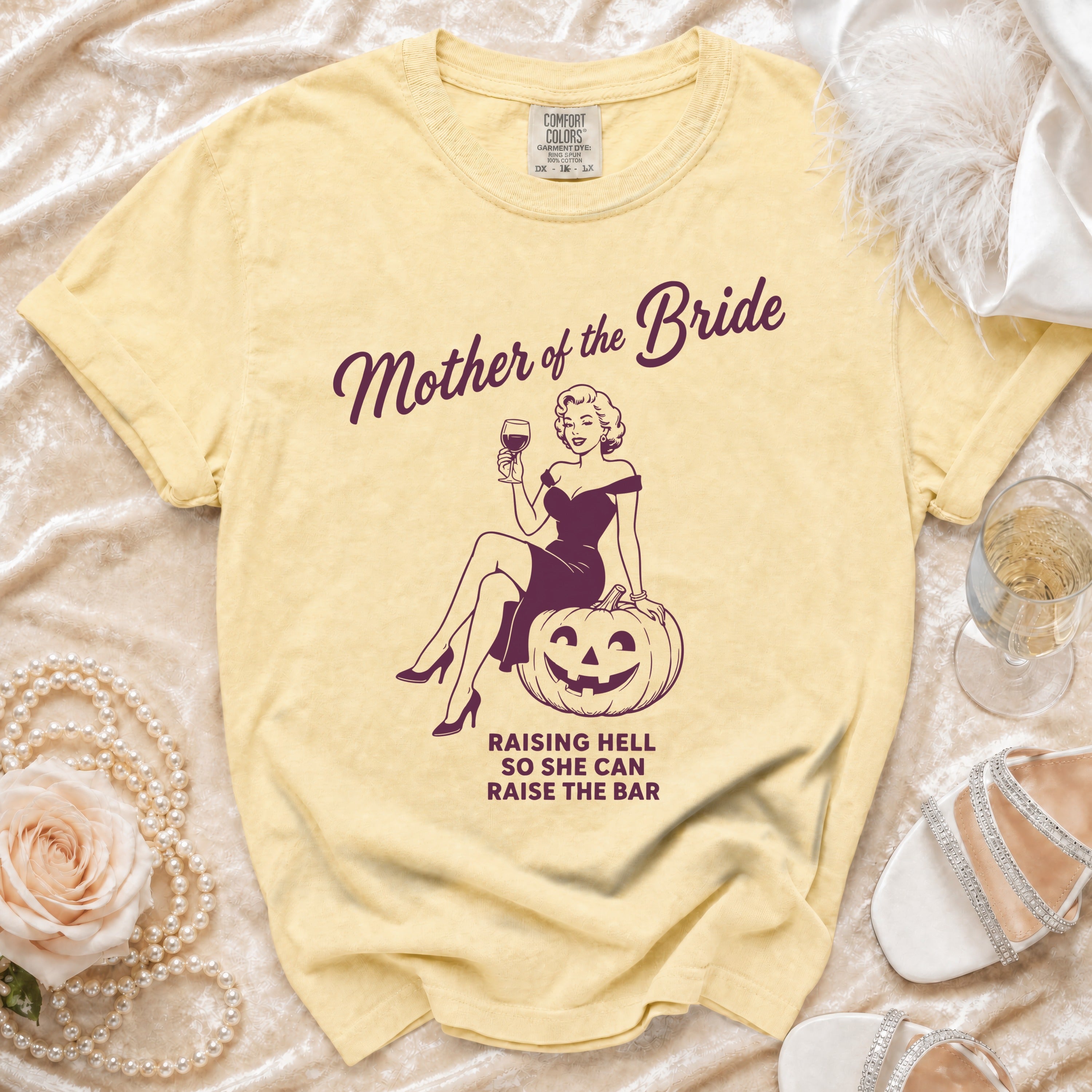 Yellow t-shirt with "Mother of the Bride" graphic and "Raising Hell So She Can Raise The Bar" text.