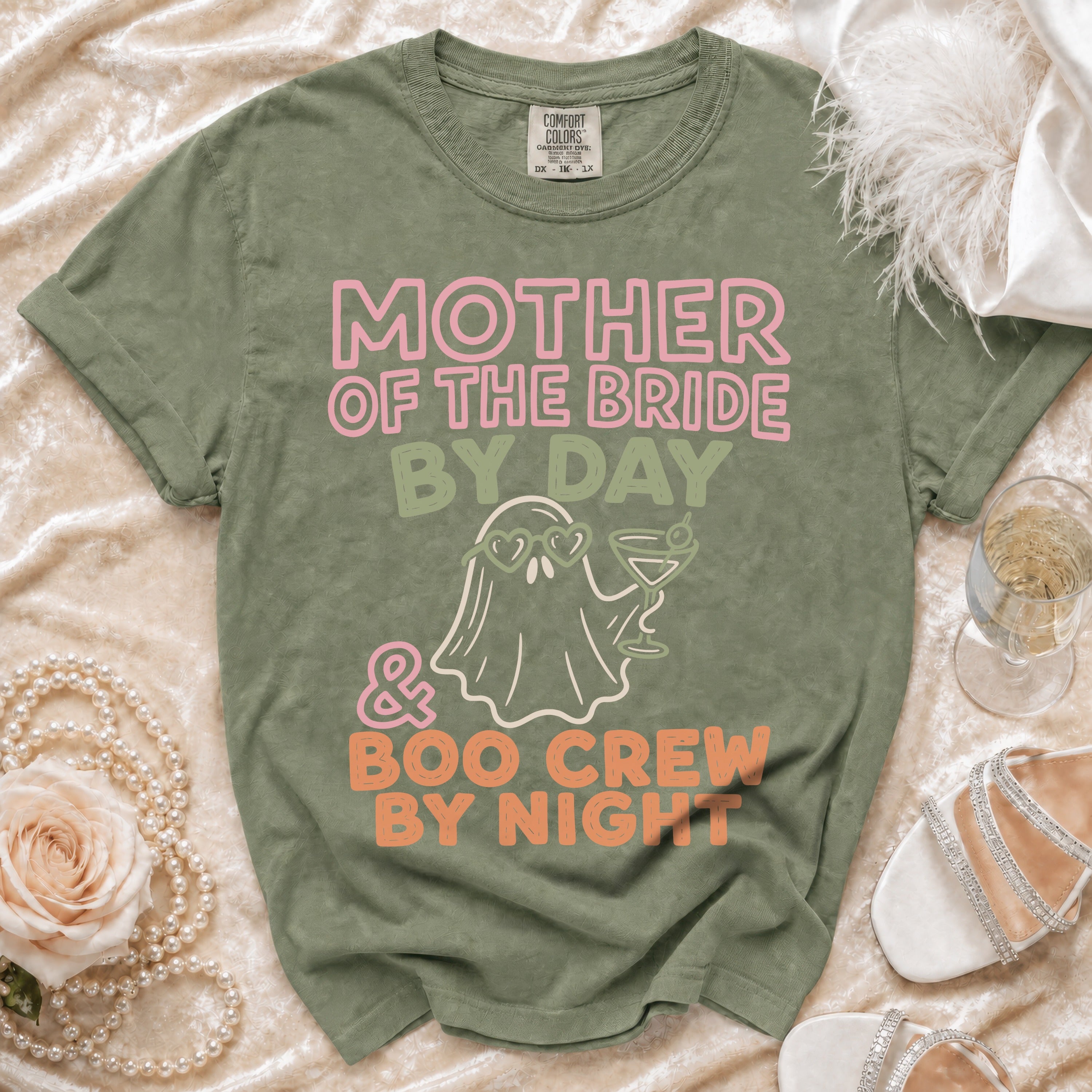 Green t-shirt with "Mother of the Bride by Day & Boo Crew by Night" graphic.