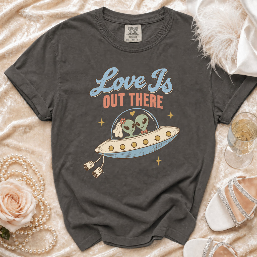 T-shirt with aliens in a UFO and text "Love Is Out There."