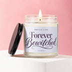 Jar candle lit with flame, lid off, labeled "Smells Like Forever Bewitched Vowed".