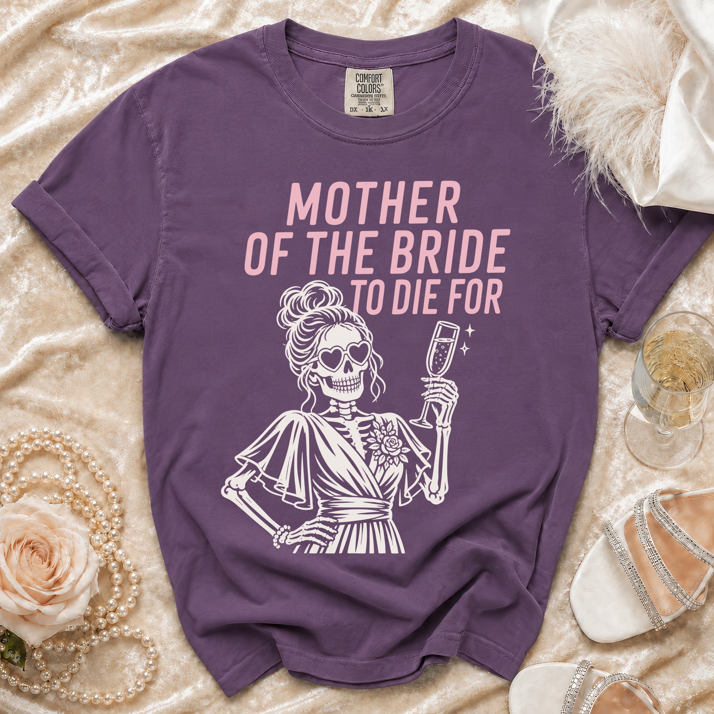 Purple t-shirt with "Mother of the Bride to Die For" text and skeleton graphic.