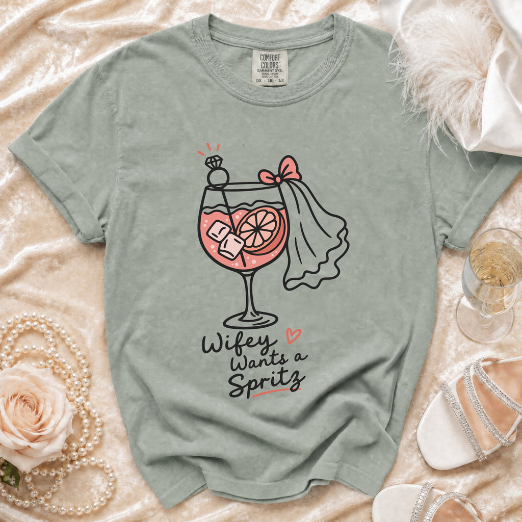 Grey t-shirt with "Wifey Wants a Spritz" graphic of a cocktail with a diamond ring.
