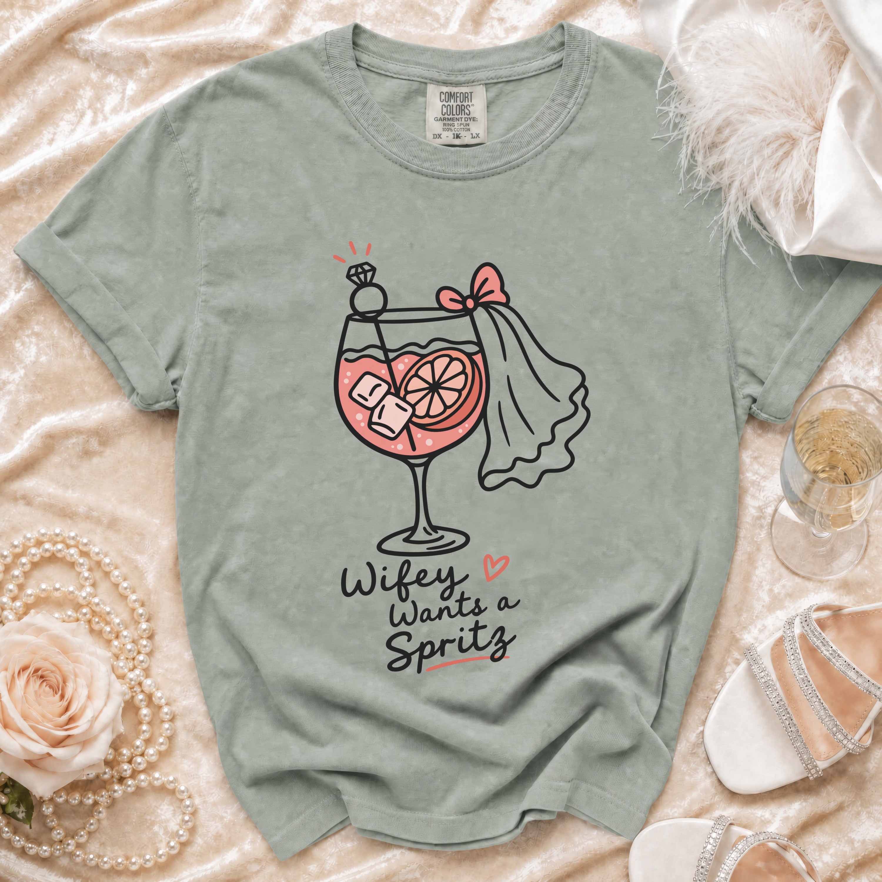 Grey t-shirt with "Wifey Wants a Spritz" graphic of a cocktail with a diamond ring.