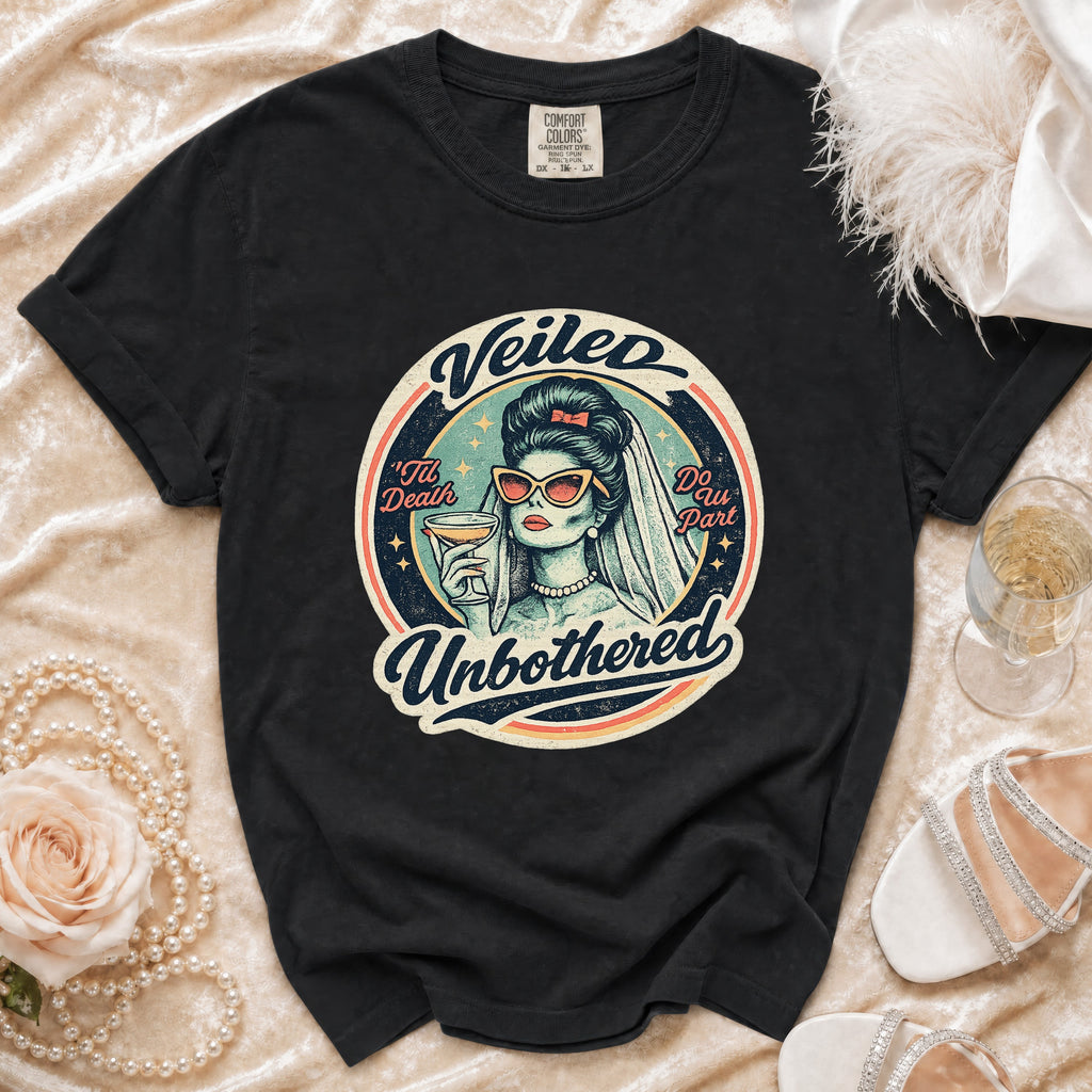 Black t-shirt with "Veiled Unbothered" bridal graphic holding a drink.