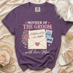 Purple t-shirt reads "Mother of the Groom" with floral and envelope graphics.