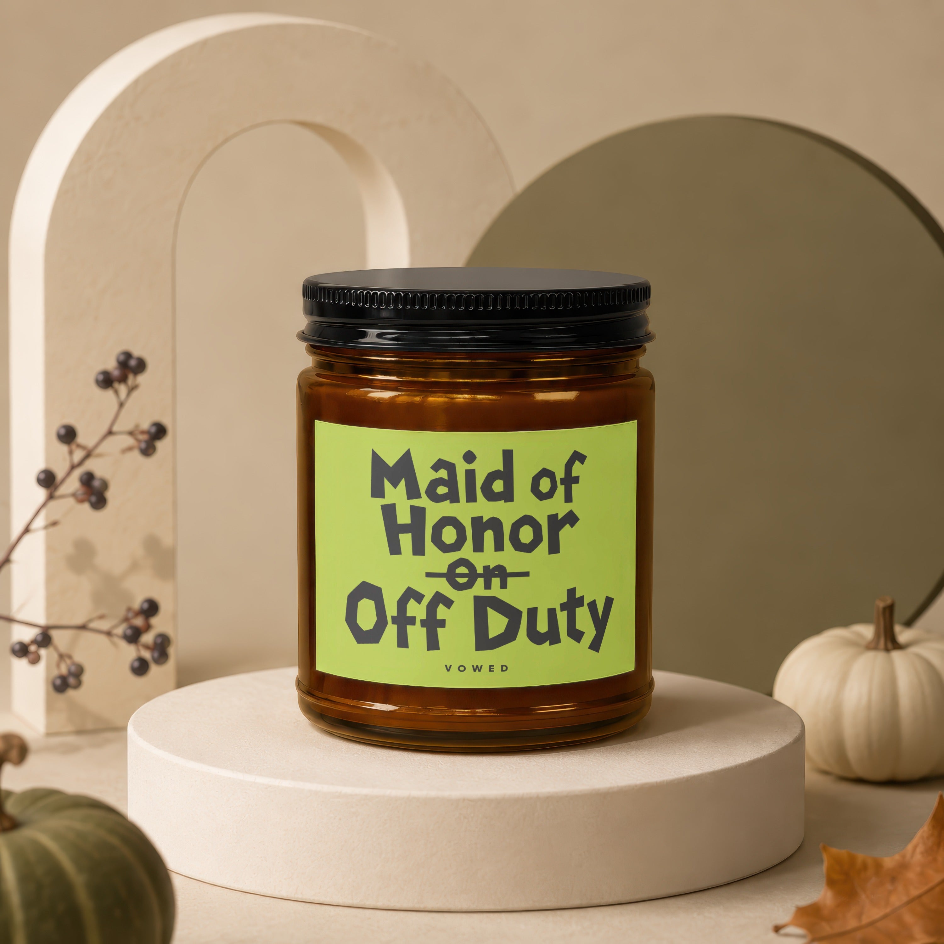 Amber jar candle with black lid, reading "Maid of Honor on Off Duty".