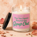 Lit candle in glass jar with pink label reading "Smells like The Yes Heard Round the Group Chat".