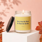 Lit candle in glass jar with yellow label that reads "You've Seen My Worst. Be There for My Best."