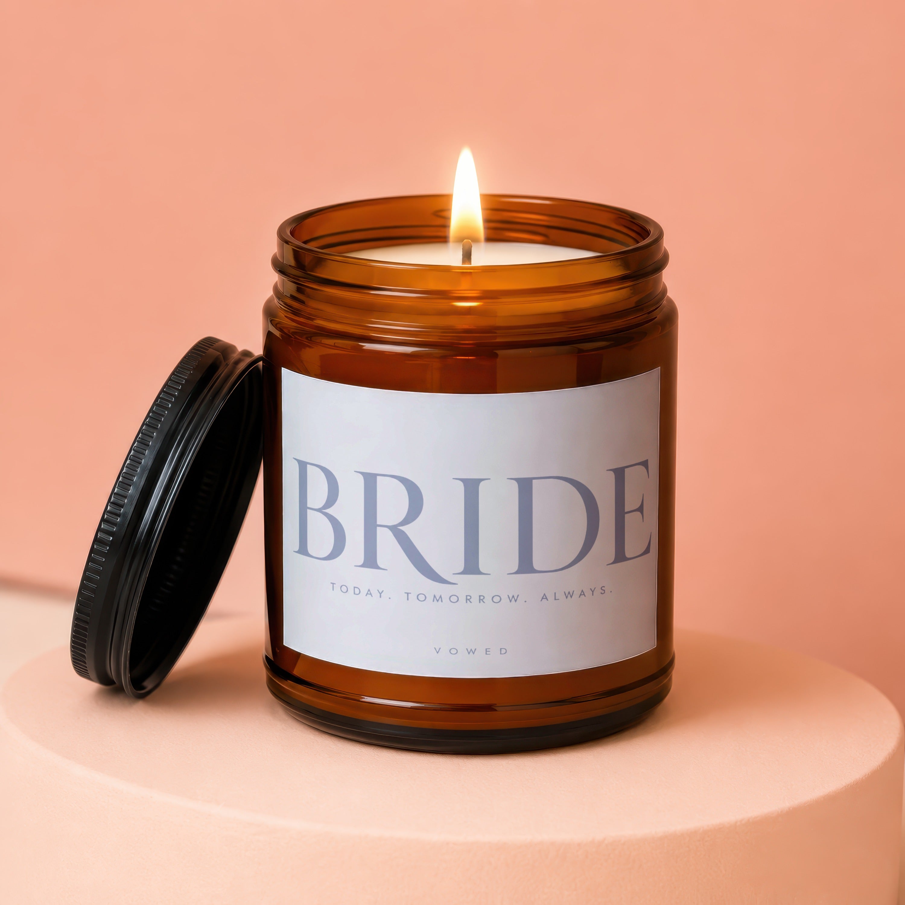 Brown glass candle lit with text "BRIDE TODAY. TOMORROW. ALWAYS. VOWED"