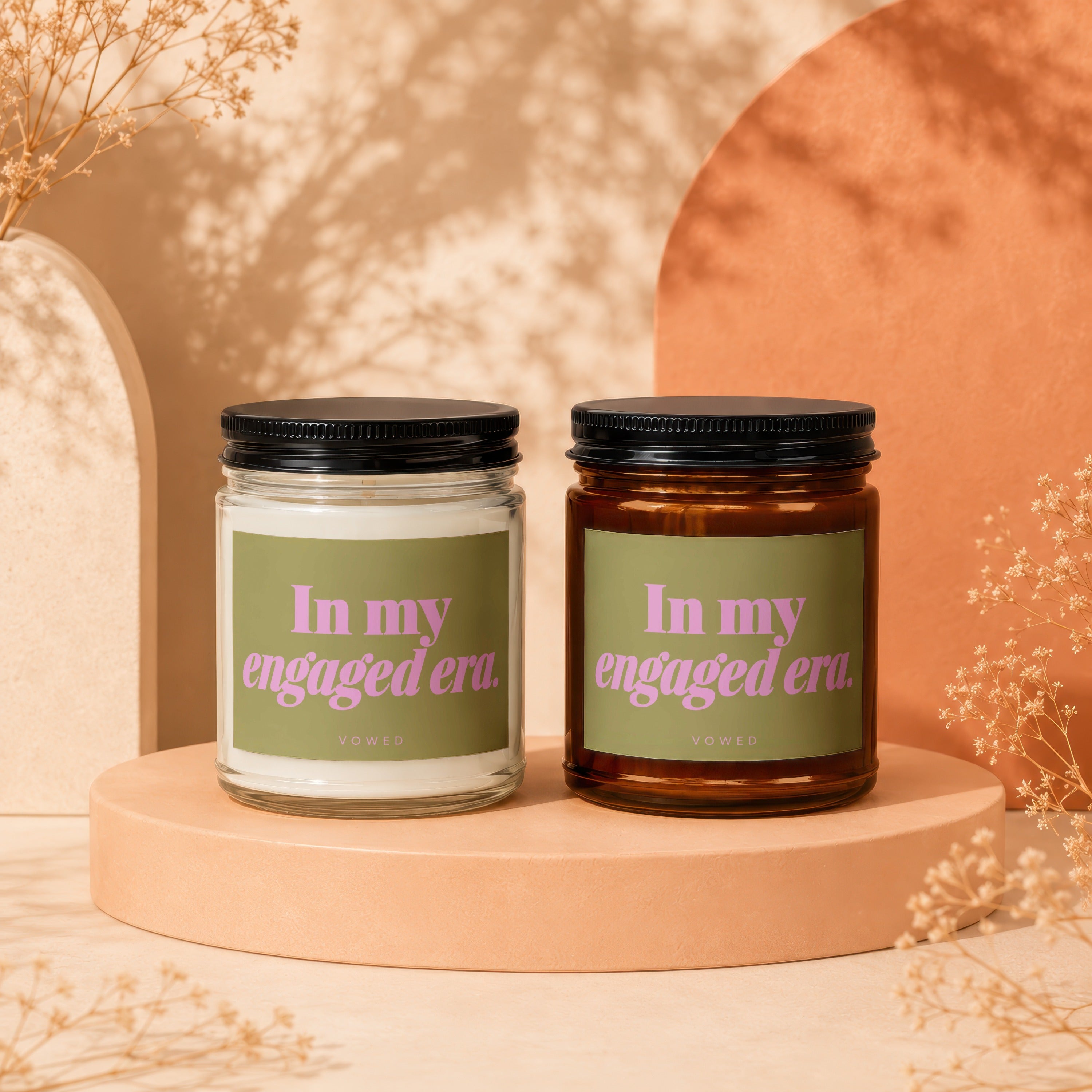 Two scented candles with "In my engaged era." text on green labels.