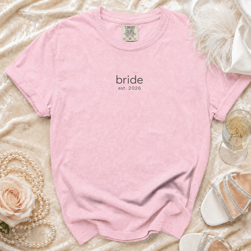 Pink t-shirt with "bride est. 2026" graphic.