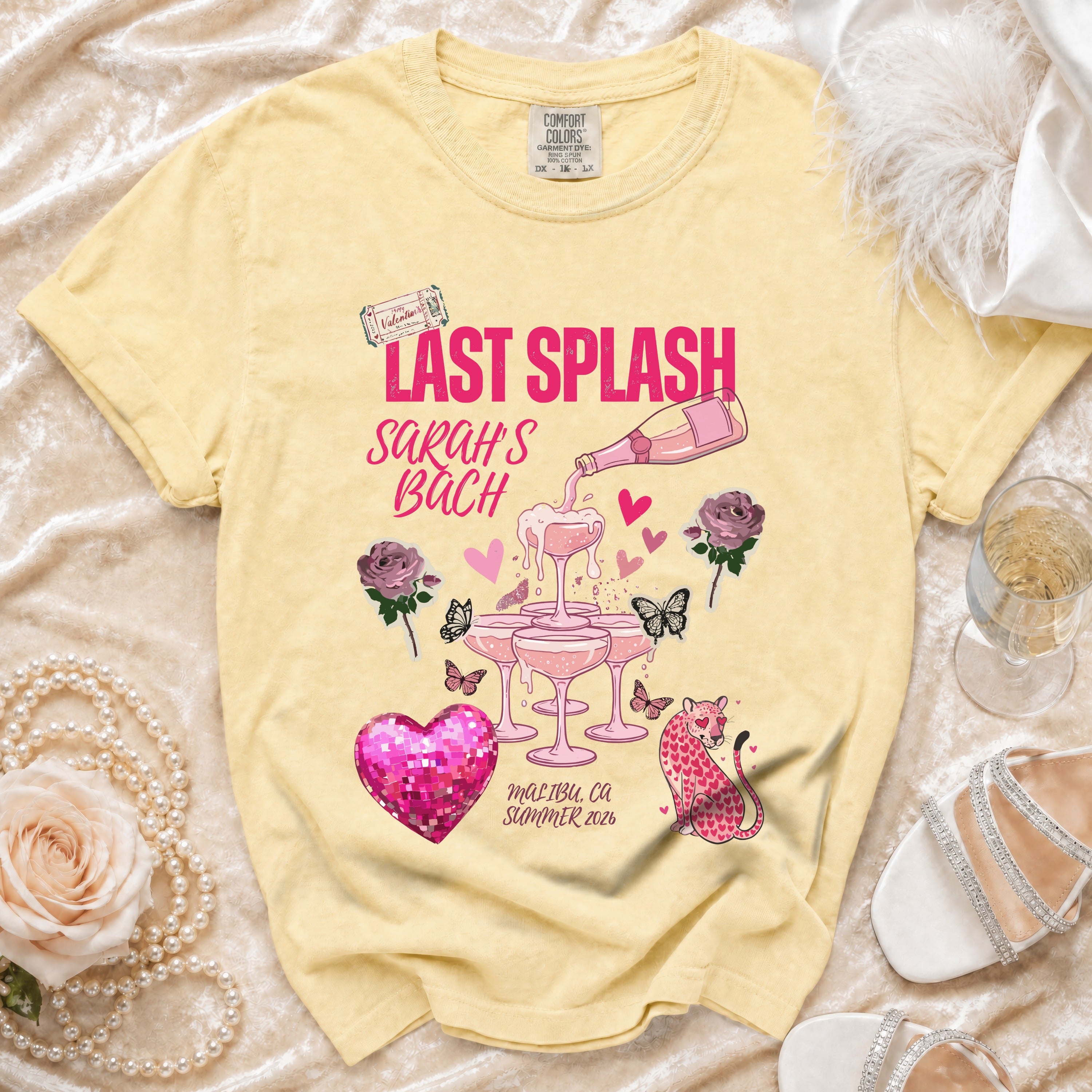 Yellow t-shirt with "Last Splash Sarah's Bach" text, champagne glasses, and pink leopard.