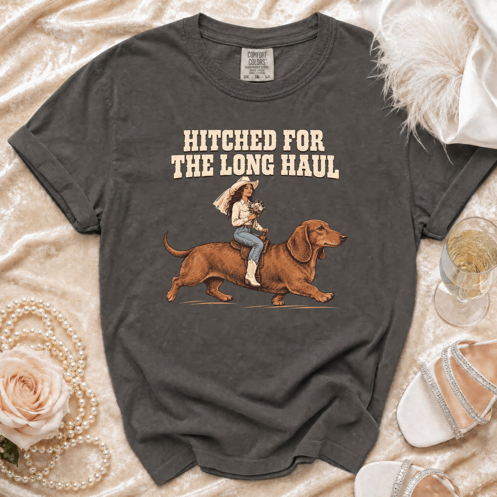T-shirt with "HITCHED FOR THE LONG HAUL" text and illustration of bride riding dachshund.