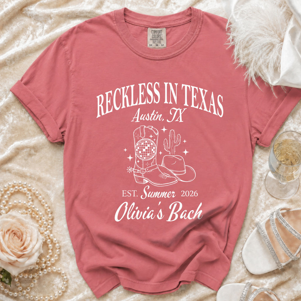 Coral t-shirt with "Reckless in Texas Austin, TX" and cowboy boot graphic.