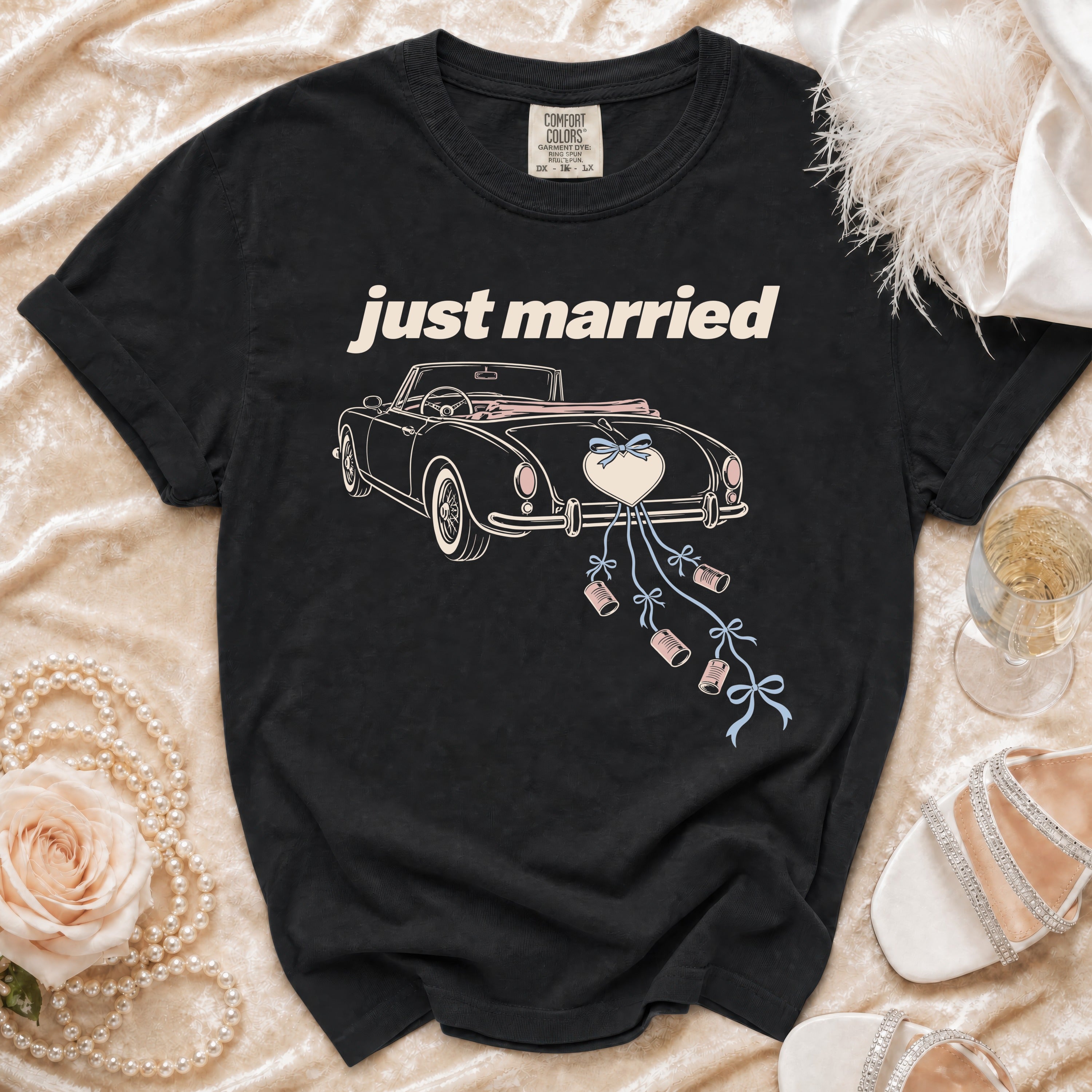 Black t-shirt with "just married" text and a vintage car illustration with cans.