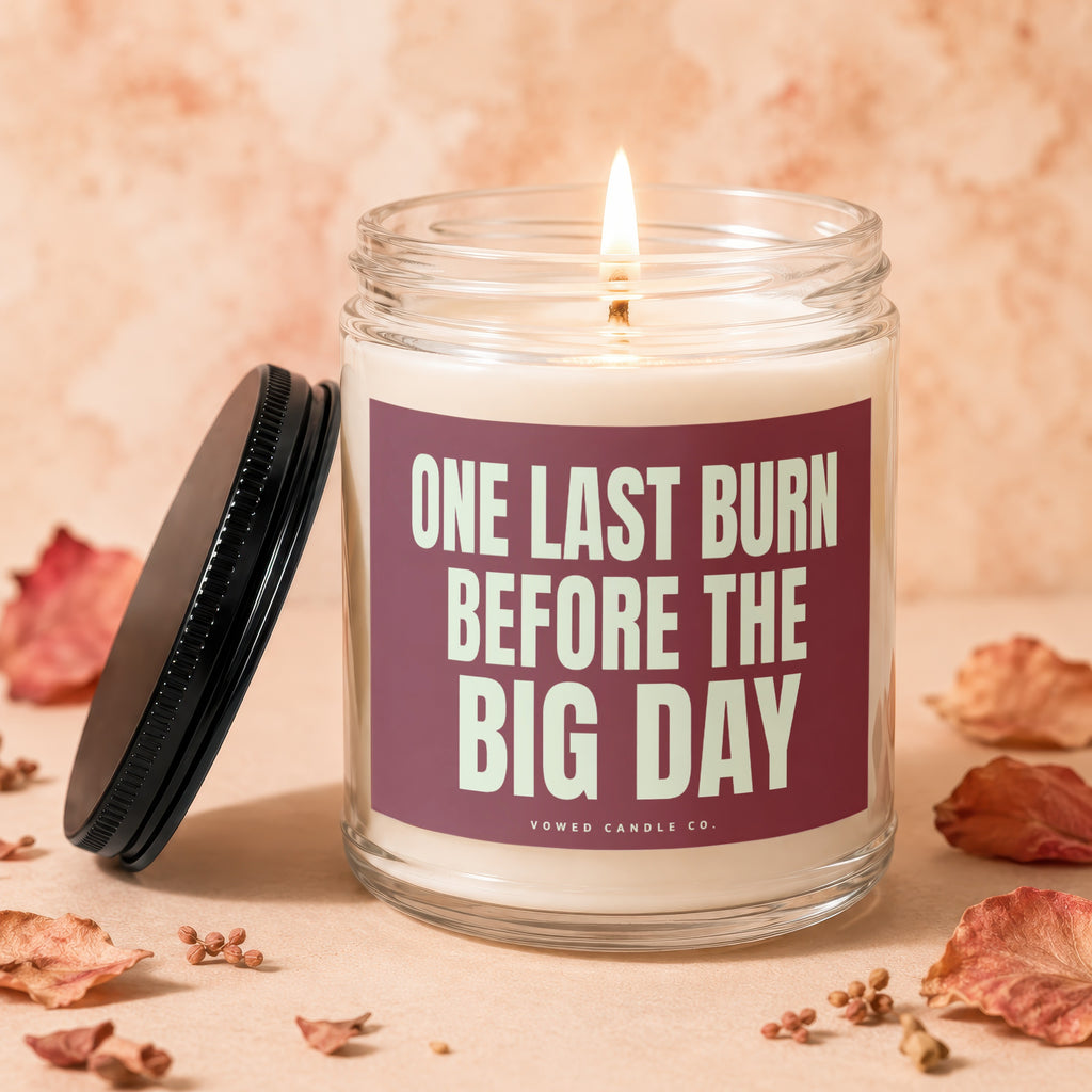 Candle with "ONE LAST BURN BEFORE THE BIG DAY" text, lit wick, and lid.