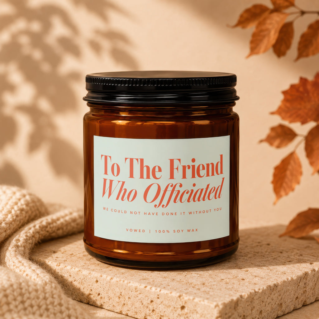 Amber jar candle with black lid, reads "To The Friend Who Officiated".