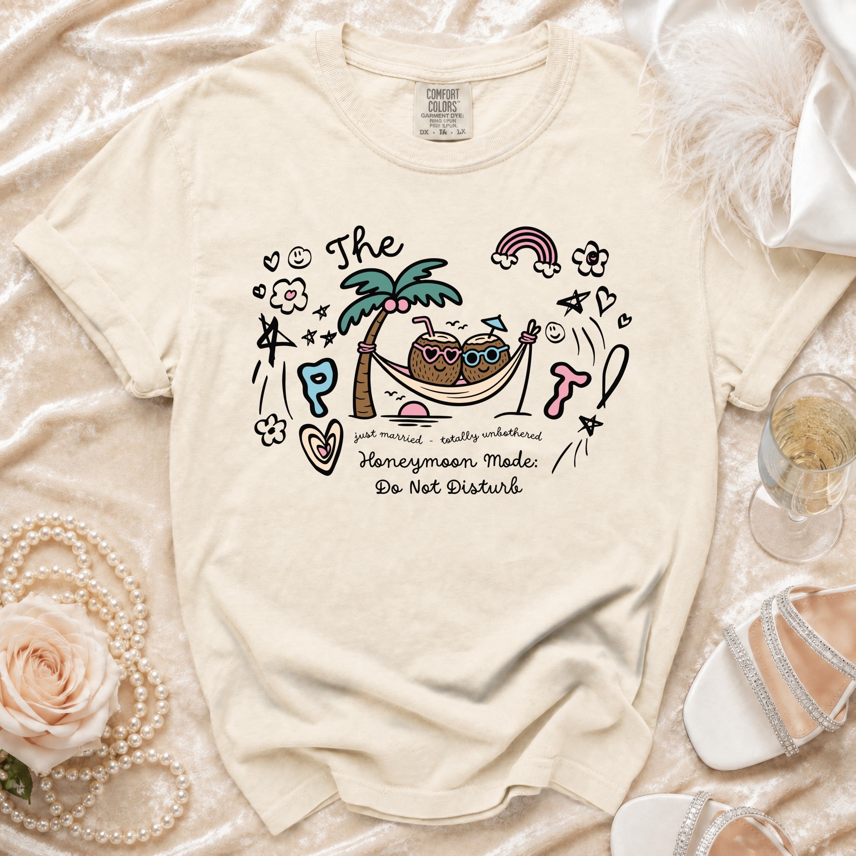 Cream t-shirt with cartoon coconuts in hammock and text "Honeymoon Mode: Do Not Disturb".