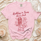Pink t-shirt with "Reckless in Texas Olivia's Bach Austin, TX Summer 2026" and cowboy motifs.