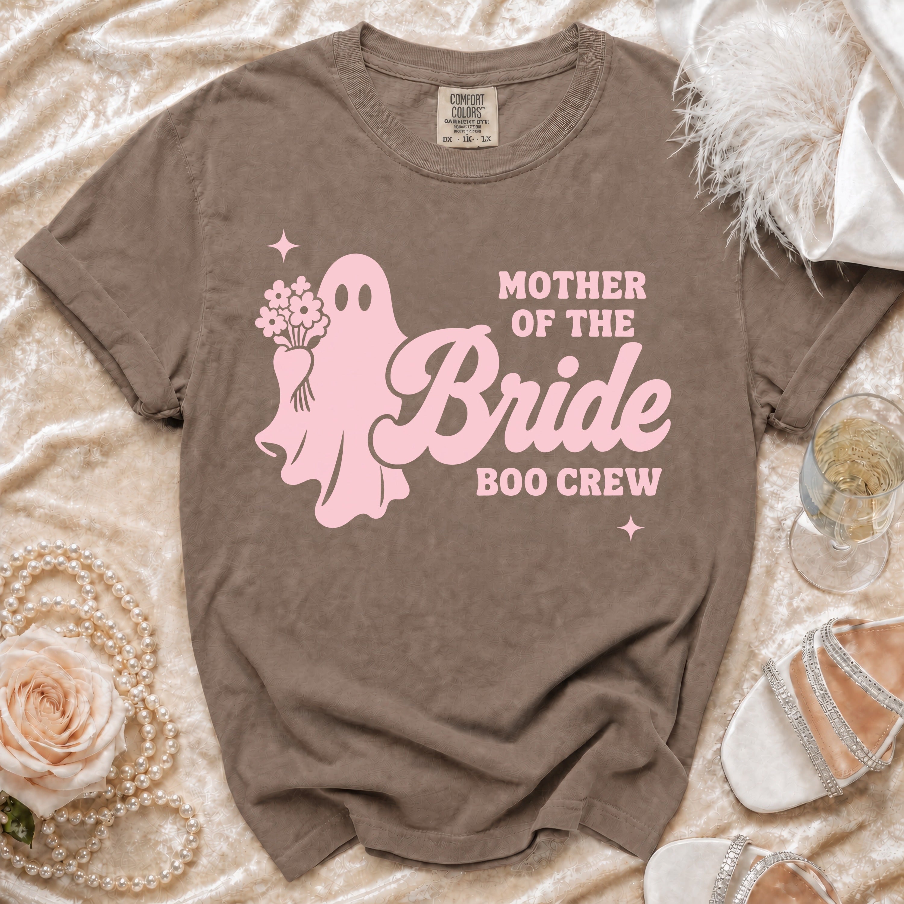 Brown t-shirt with pink ghost graphic saying "MOTHER OF THE BRIDE BOO CREW".
