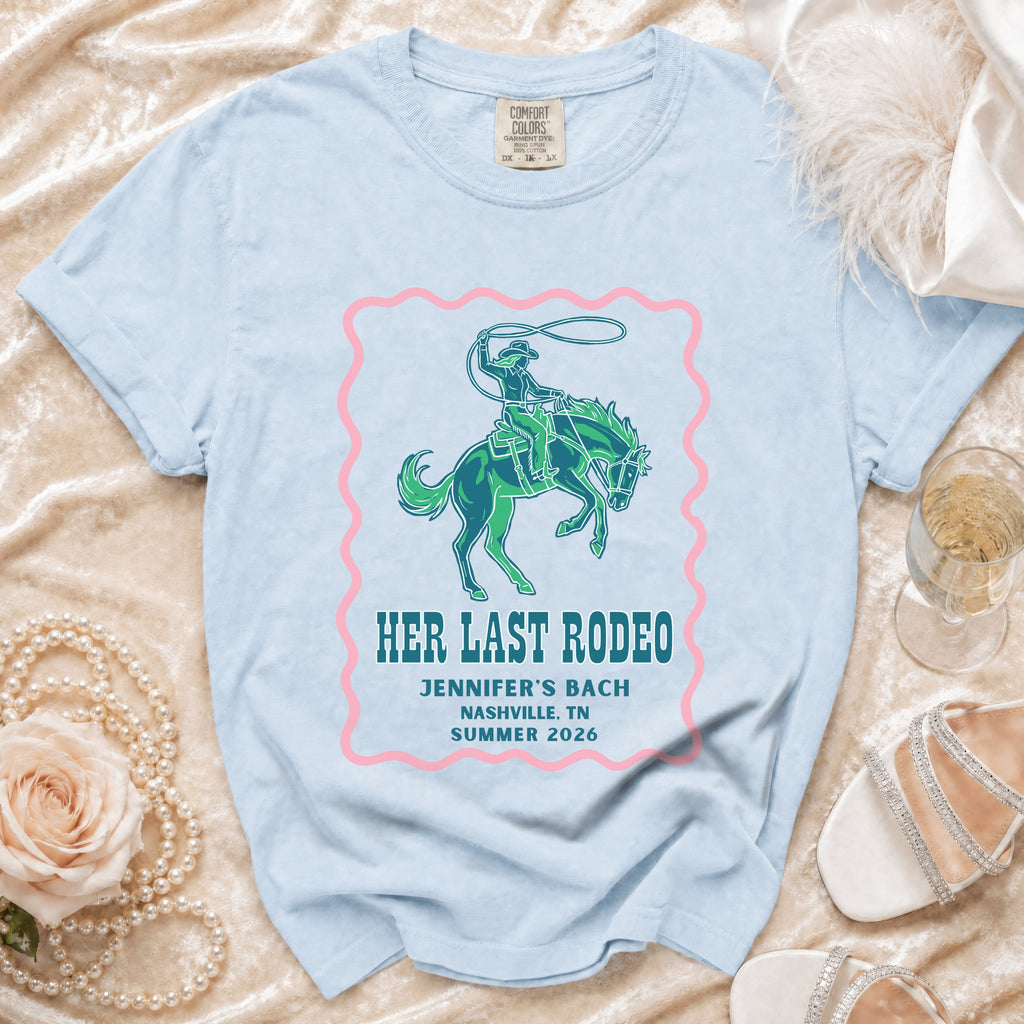 Light blue t-shirt with "Her Last Rodeo" text and cowboy graphic.