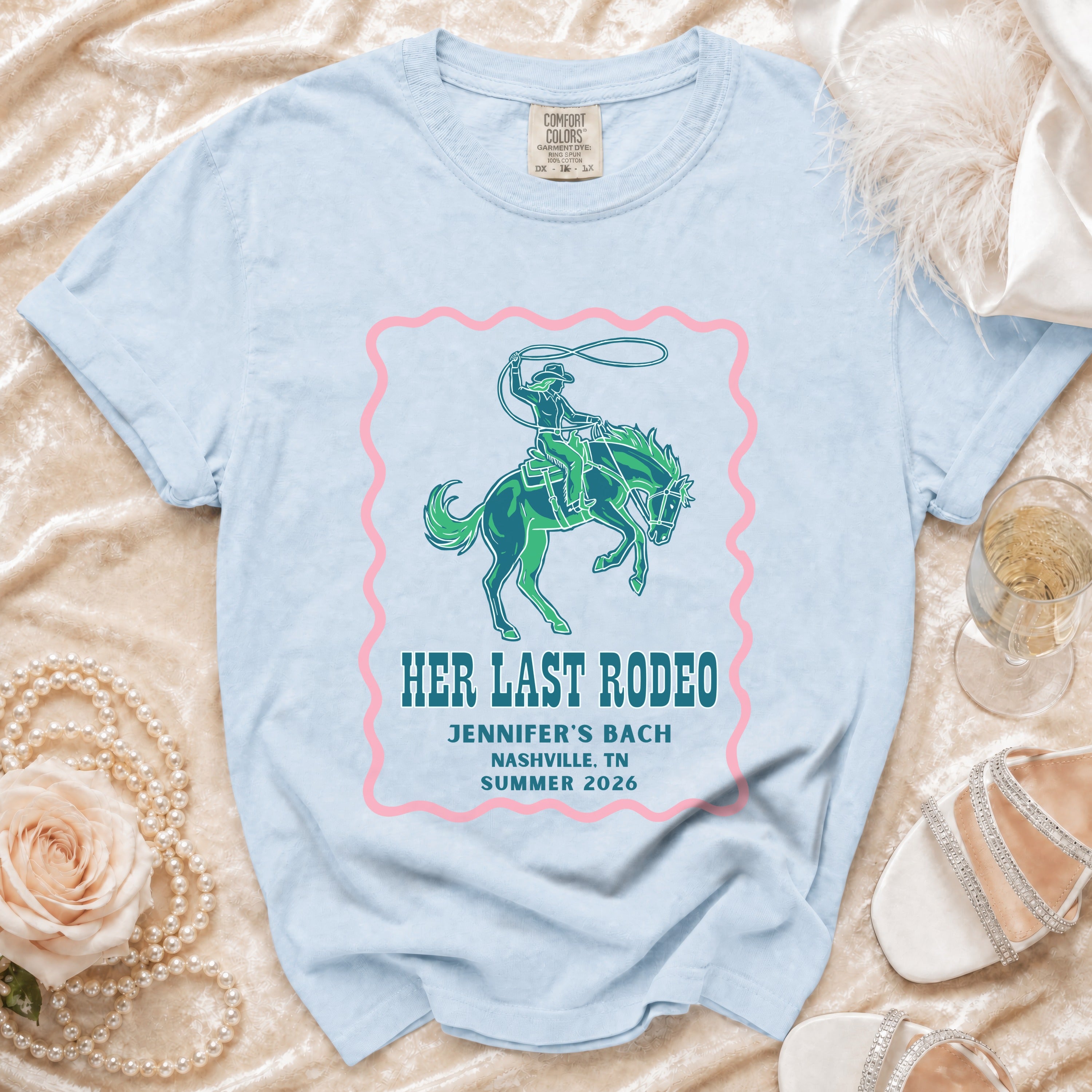 Light blue t-shirt with "Her Last Rodeo" text and cowboy graphic.